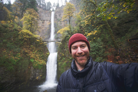Man standing in front of Multnomah Falls
