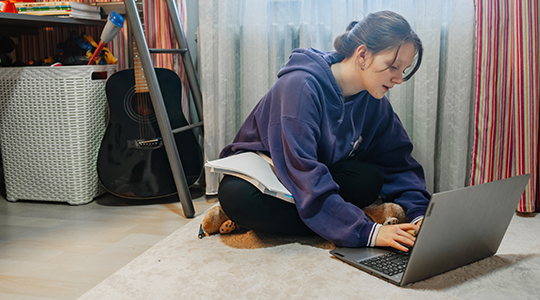 teenage girl studying in her room