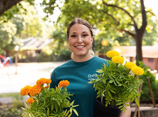 Volunteering for onpoint with nonprofit holding flowers