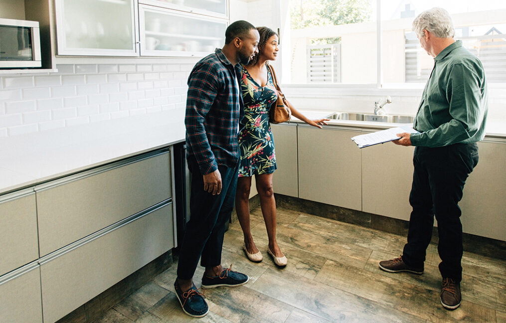 couple looking at a home with a real estate agent