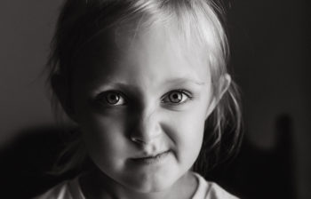 Black and white photo of young girl smirking