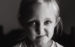Black and white picture of young girl smirking at camera