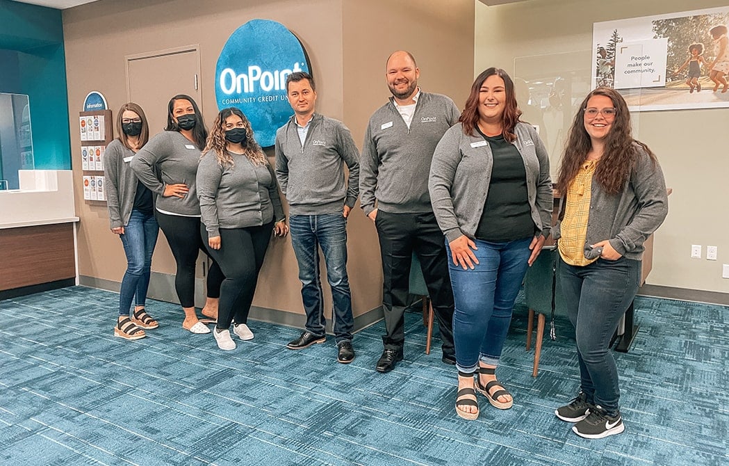 Team members of the OnPoint Orchards Branch line up to celebrate the opening of their new branch.