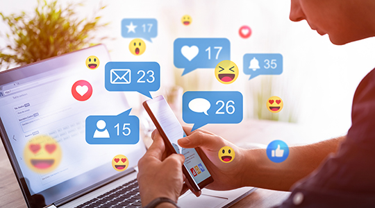 Like and share social media. Hands holding smartphone with social media network icons.