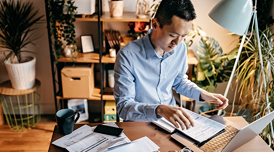 Young man calculating and submitting application online