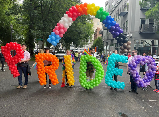 people holding pride balloons at the pride festival