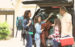 Family packs vehicle for autumn vacation trip.
