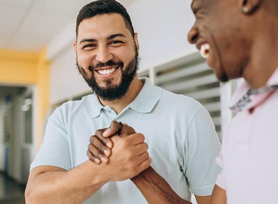 Two male friends holding hands