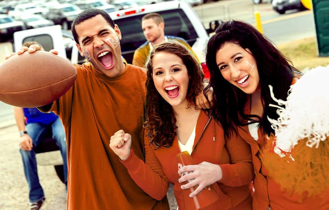 football fans cheering at a tailgate