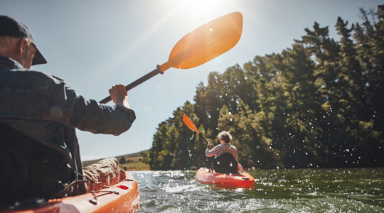 Senior couple kayaking in a lake