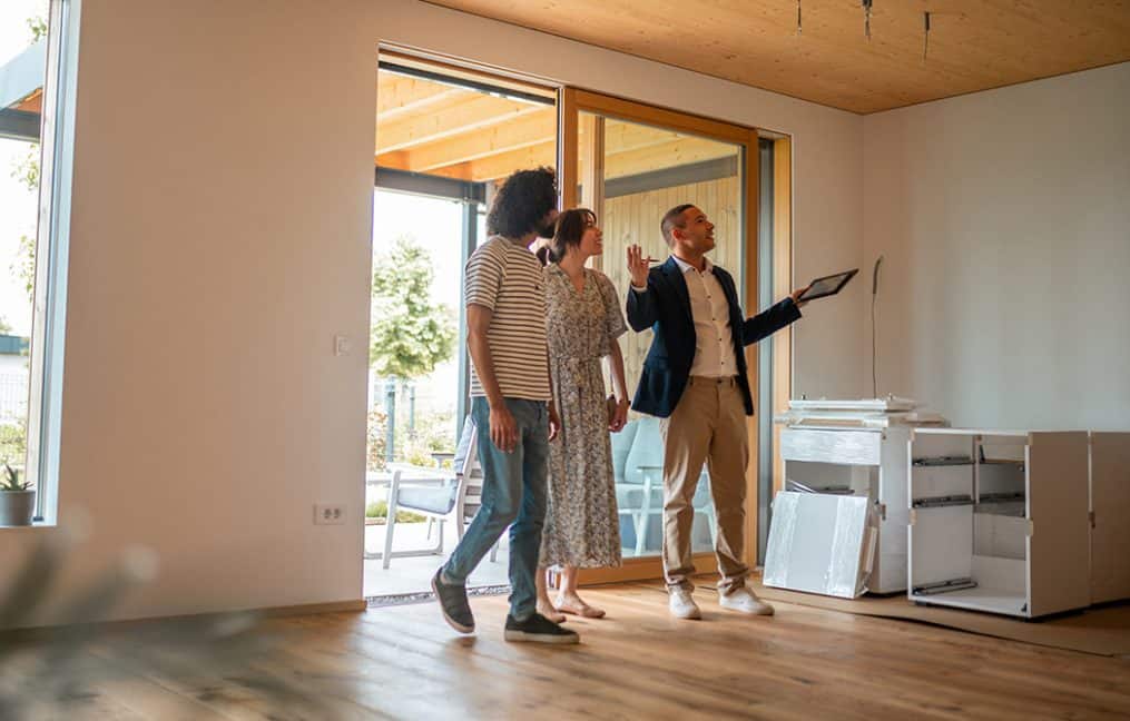 couple walking through home with realtor buying new home simplifying the homebuying process onpoint