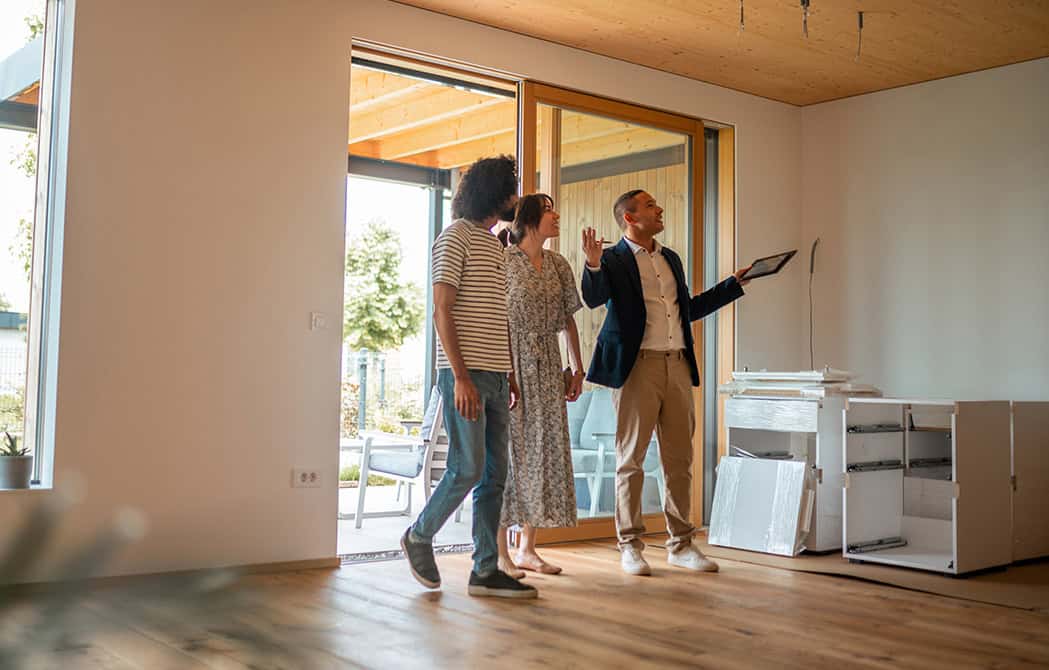 couple walking through home with realtor buying new home simplifying the homebuying process onpoint