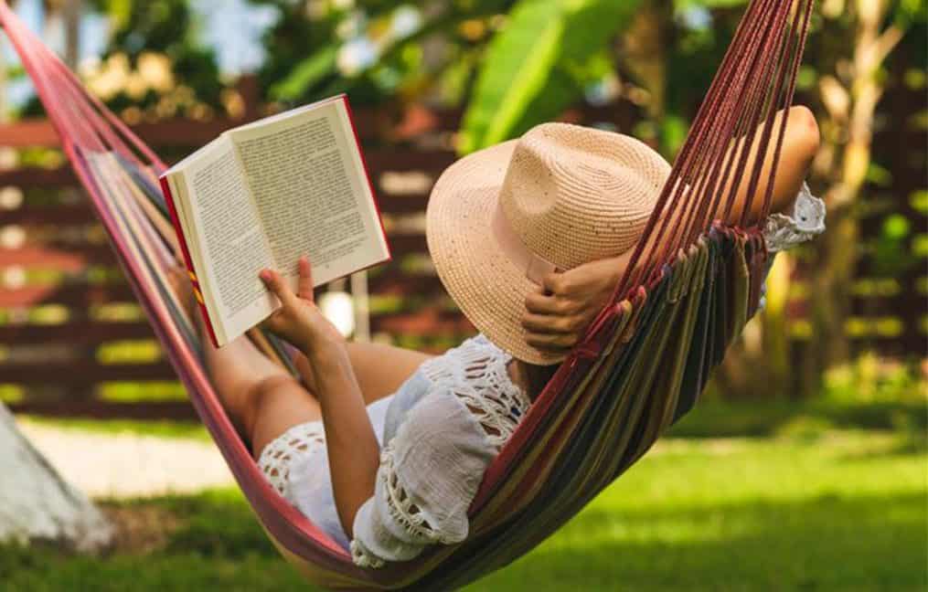 2026 summer skip pay onpoint community credit union woman in hammock reading a book in summer