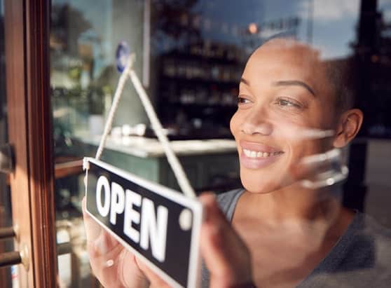 Business owner turning over their open sign