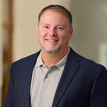 Roger Trotman OnPoint Mortgage Professional Headshot Bank Back drop
