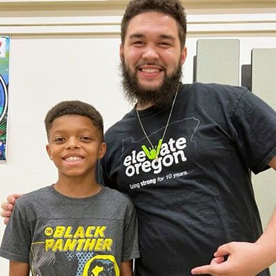 Jalen and elementary school student smiling 