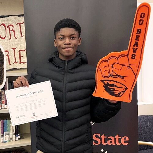 student holding acceptance letter to college