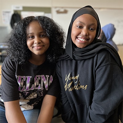 two girls smiling in the classroom 