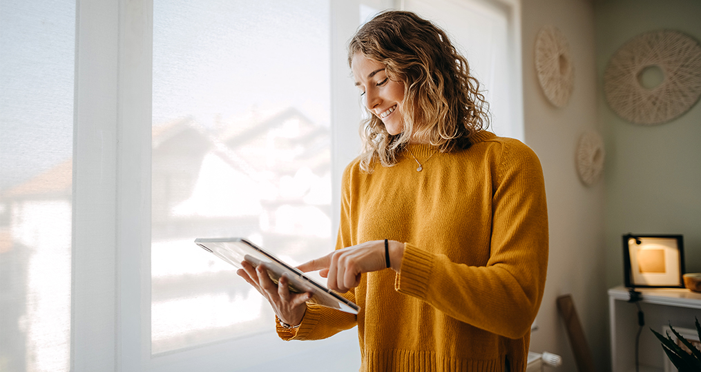 business woman using a digital tablet while working from home