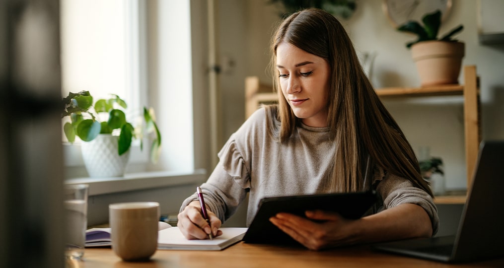 woman drinking coffee and using computer