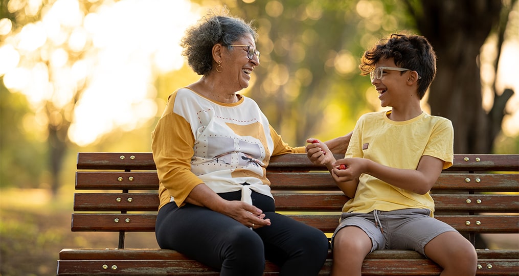 grandmother and grandson sitting on the bench