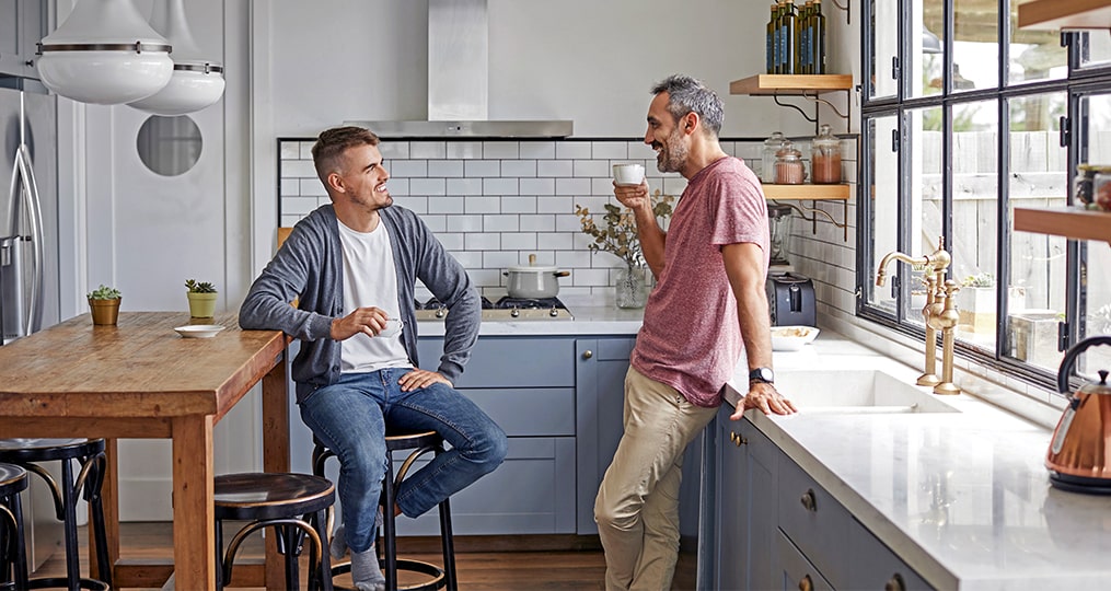 10 things your kids do not want when you downsize-father and son talking in the kitchen