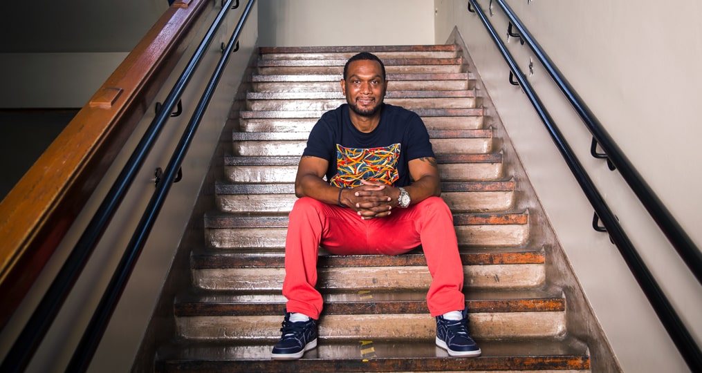 2021 Educator of the Year Lionel Clegg prepares students for life-Lionel sitting on stairs at Woodlawn Elementary School