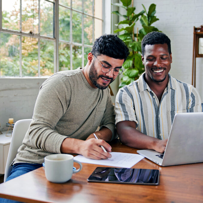 3 tips for sticking to your budget-two men reviewing a household budget together