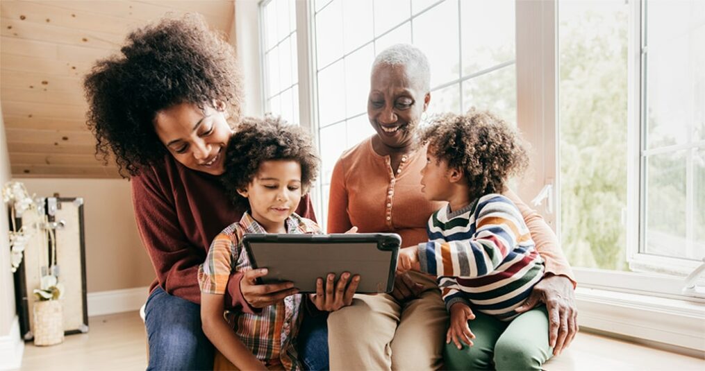 Black family looking at a tablet