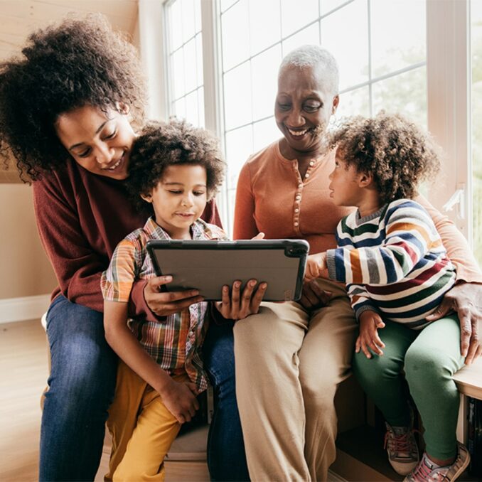 Black family looking at a tablet