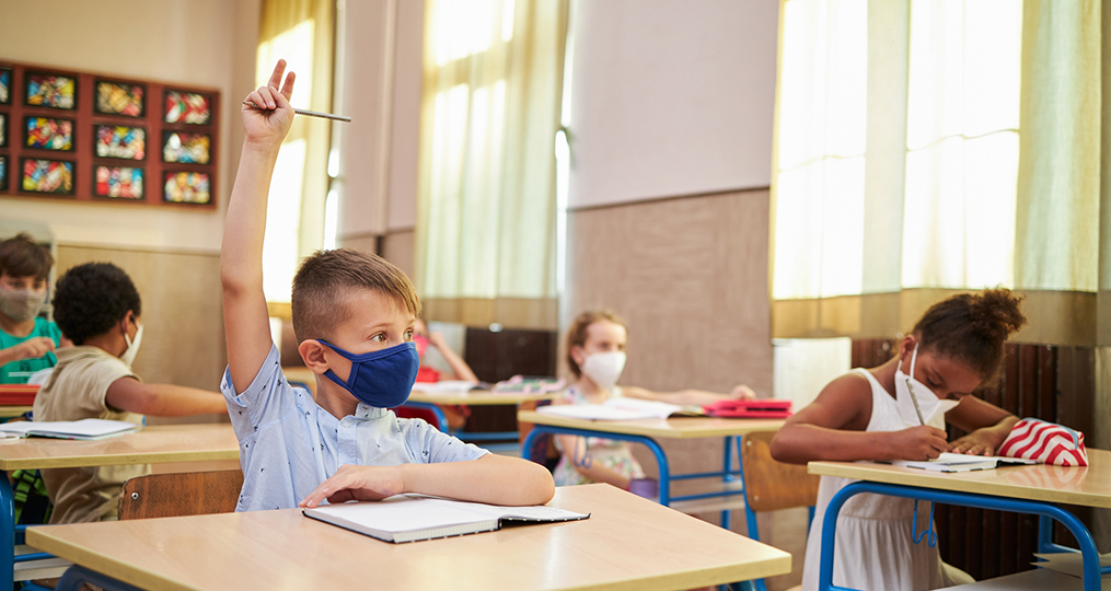 Honoring Educators During Unprecedented Challenges-student raising hand to talk in classroom