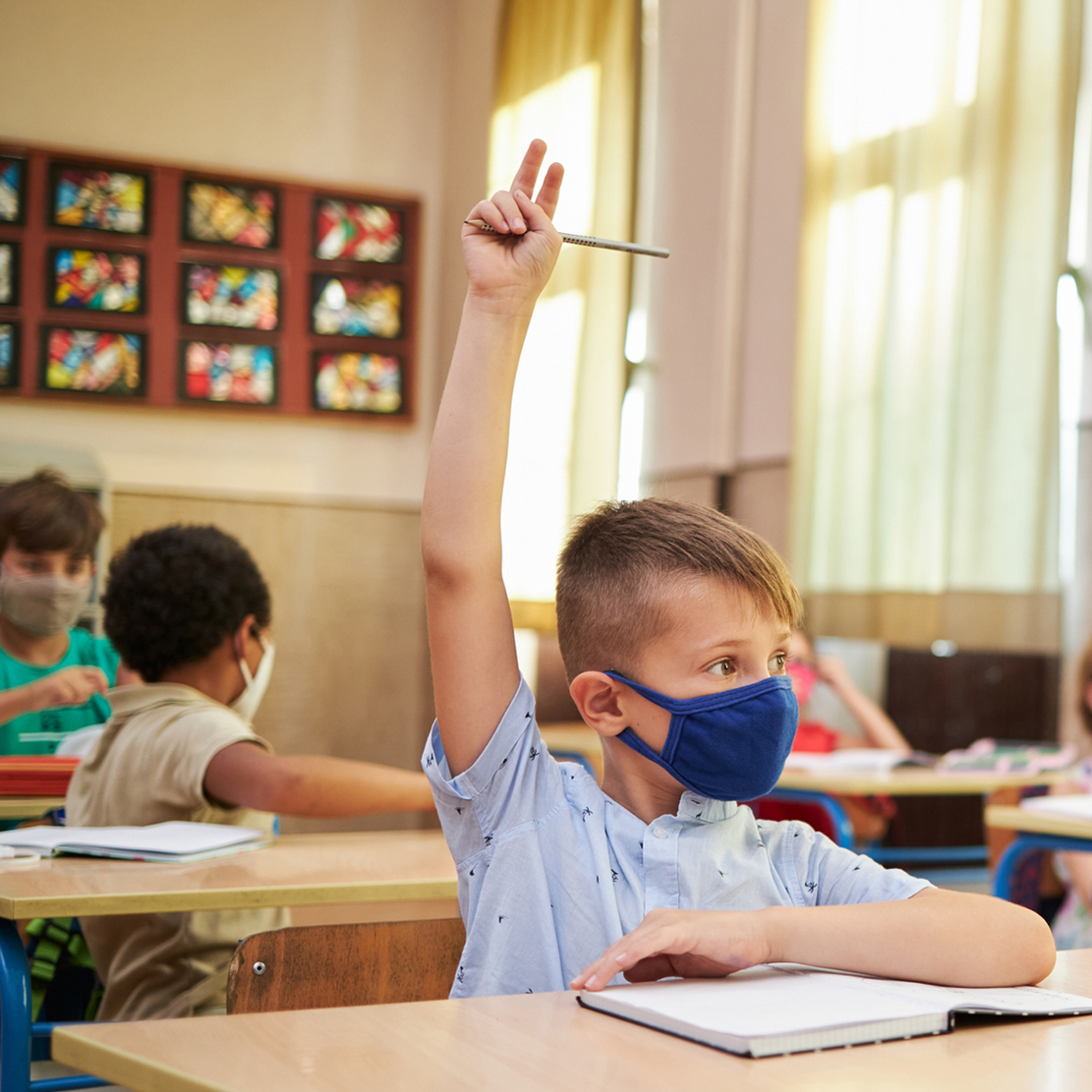 Honoring Educators During Unprecedented Challenges-student raising hand to talk in classroom