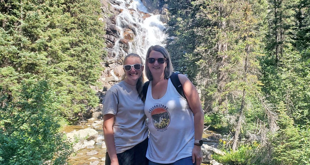 Jennifer Schmitz Employee Spotlight- Jenny and her daughter at a PNW waterfall