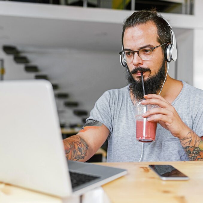 Loans 101—which loan is best for you-main with beard drinking smoothly using laptop