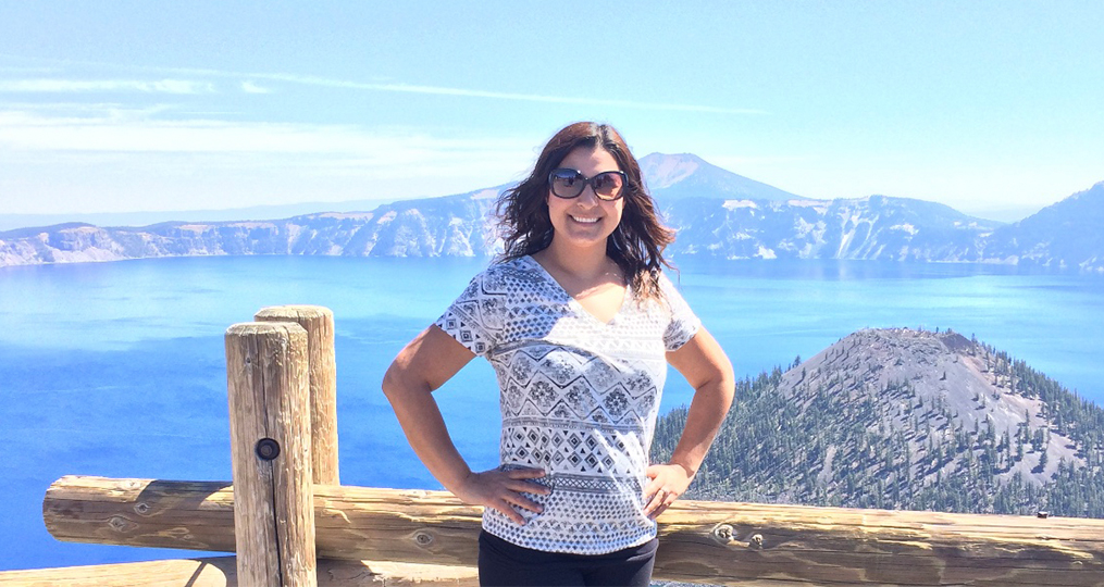 Marlen posing in front of a scenic mountain and lake view in the pacific northwest