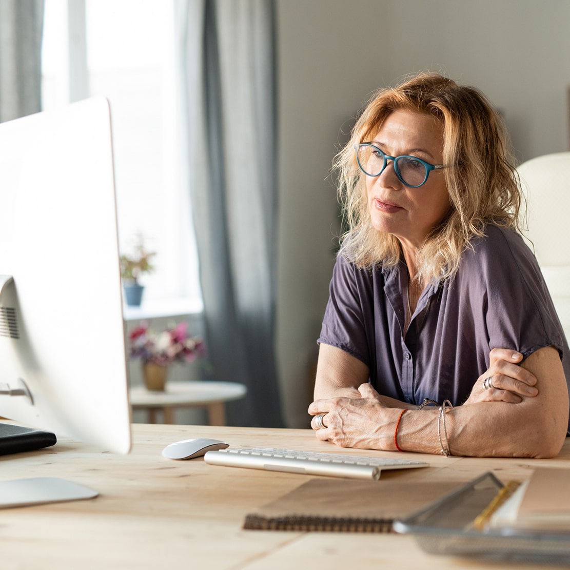 What Should You Ask a Financial Advisor-mature woman considering while looking at computer