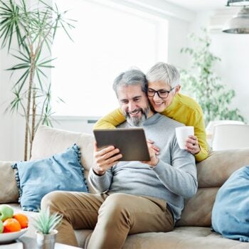 elderly couple looking at a tablet together