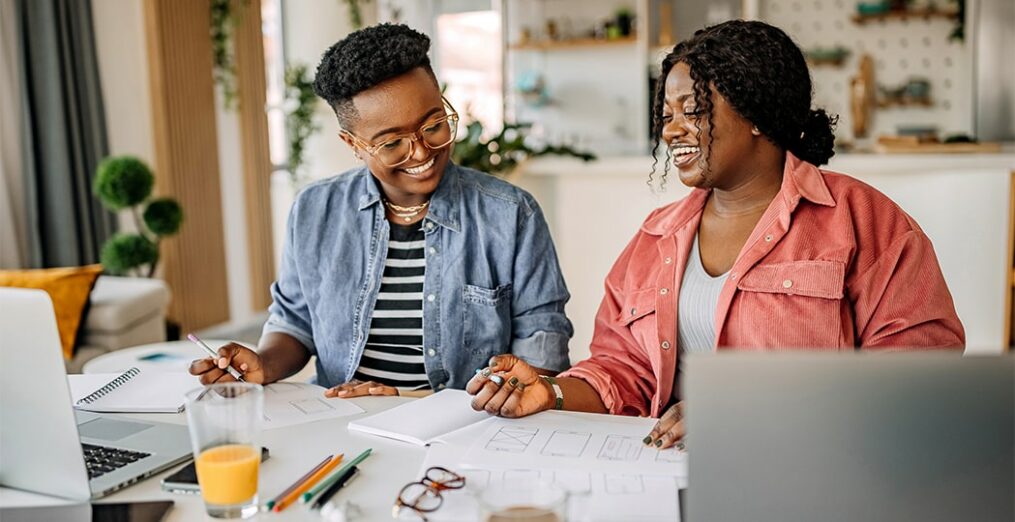 two black women looking at documents.