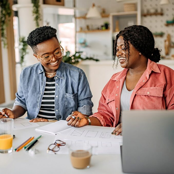 two black women looking at documents.