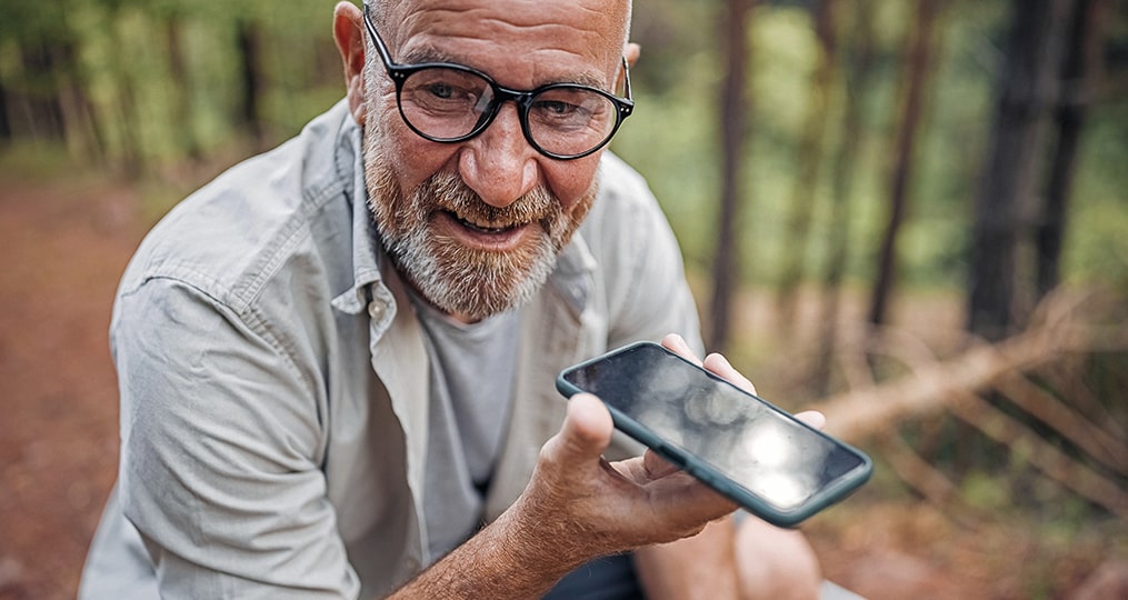 correcting your retirement course-man speaking on a cell phone in the woods