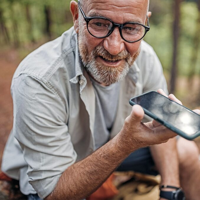 correcting your retirement course-man speaking on a cell phone in the woods