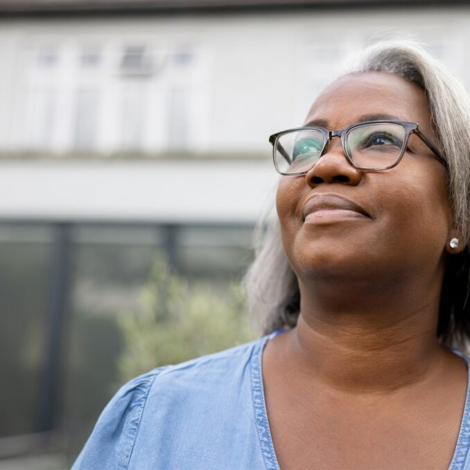 lending discrimination series part 1-confident woman standing in front of house