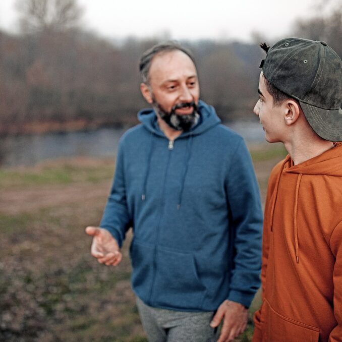loved ones legacies and life insurance-father and son walking and talking