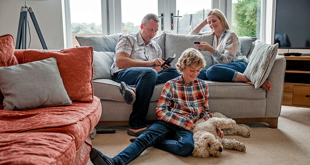 raising smart spenders and savers-family sitting in the living room