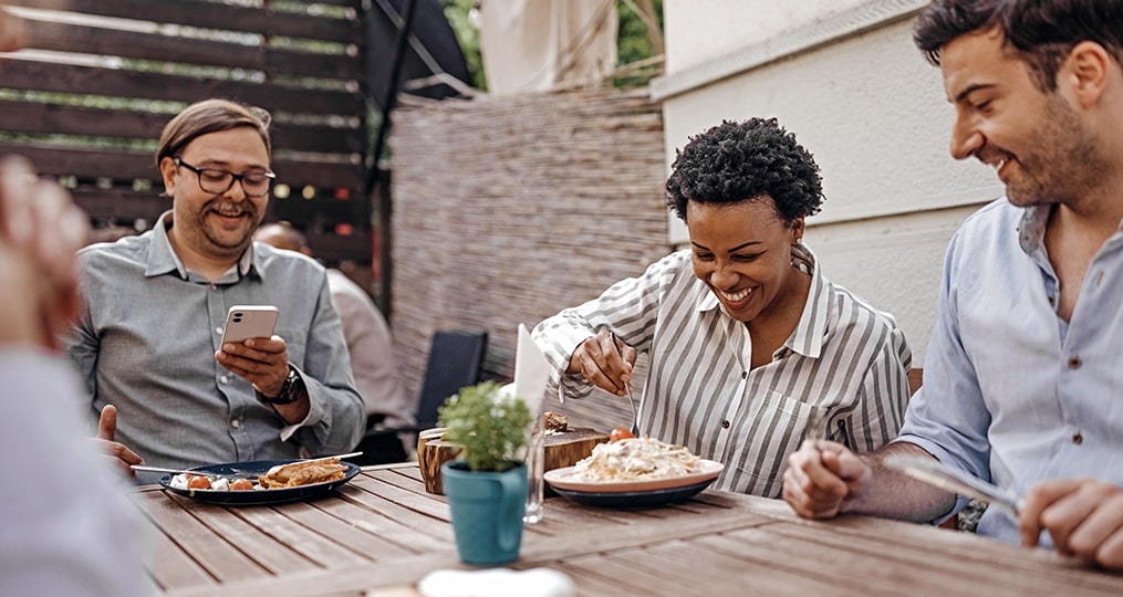 the friendship wealth gap-group of friends having lunch together at a restaurant