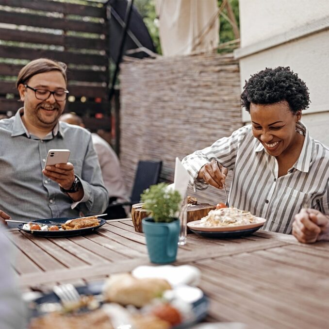 the friendship wealth gap-group of friends having lunch together at a restaurant