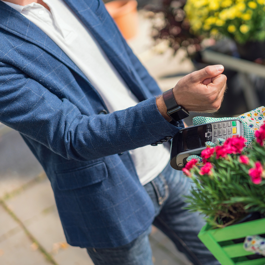 The Pros and Cons of Popular Payment Methods_man using contactless payment at local flower shop