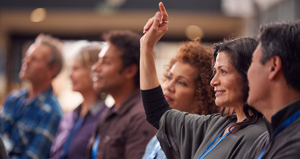 Understanding the Differences Among Popular Retirement Account Options_mature woman raising hand to ask a question