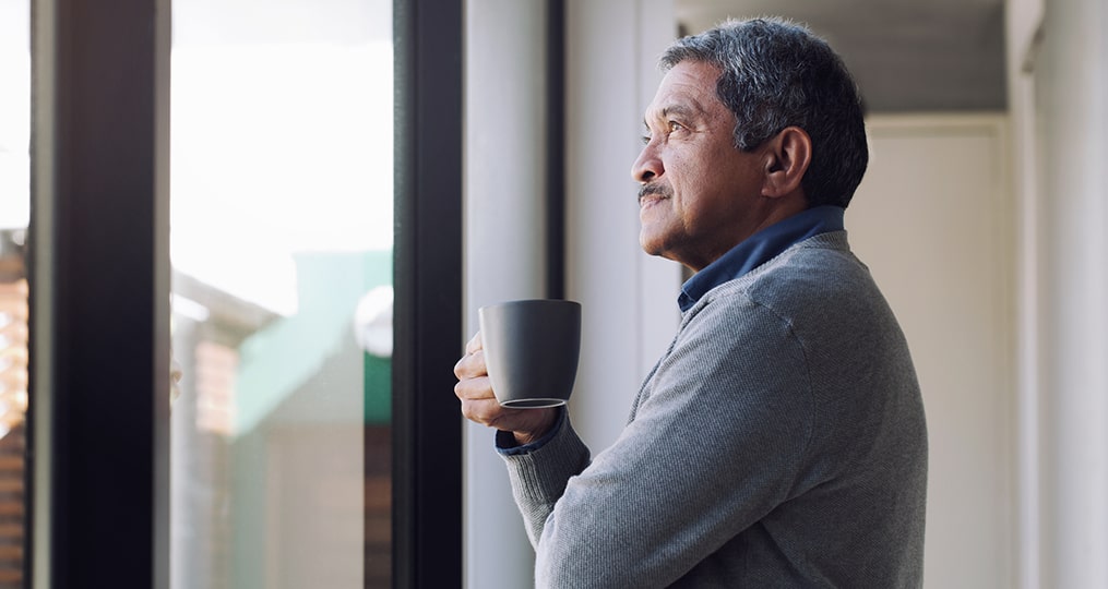 What to Do If You're Not on Track for Retirement_senior drinking coffee while looking out a window