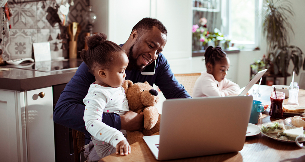 When Should You Ask for an Increase to Your Credit Card Limit_Man talking on the phone while multitasking with his two young daughters